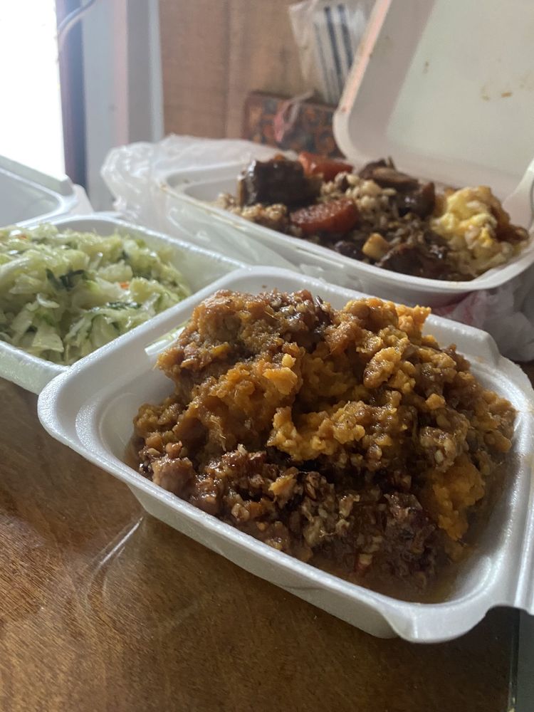 Takeout spread of Kemper's Cafe sides — sweet potato souffle, cabbage, and seasoned plates